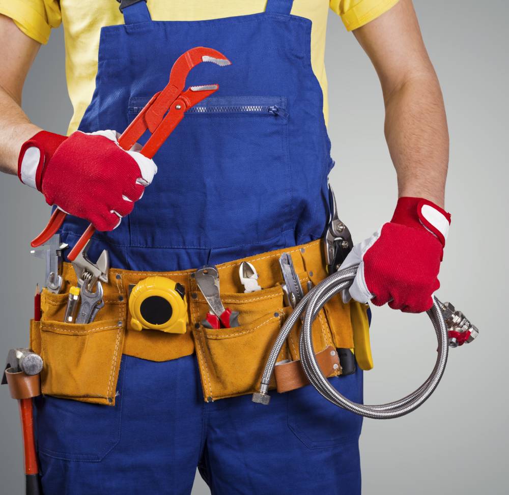 Image of fake plumber wearing overall costume and yellow toolbelt for Simply Plumbing website